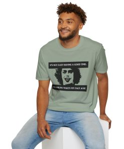 'It's not easy having a good time...even smiling makes my face ache' on a shirt in the color Sage. - Memento Mary