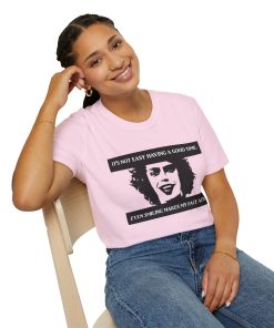 'It's not easy having a good time...even smiling makes my face ache' on a shirt in the color Light Pink. - Memento Mary